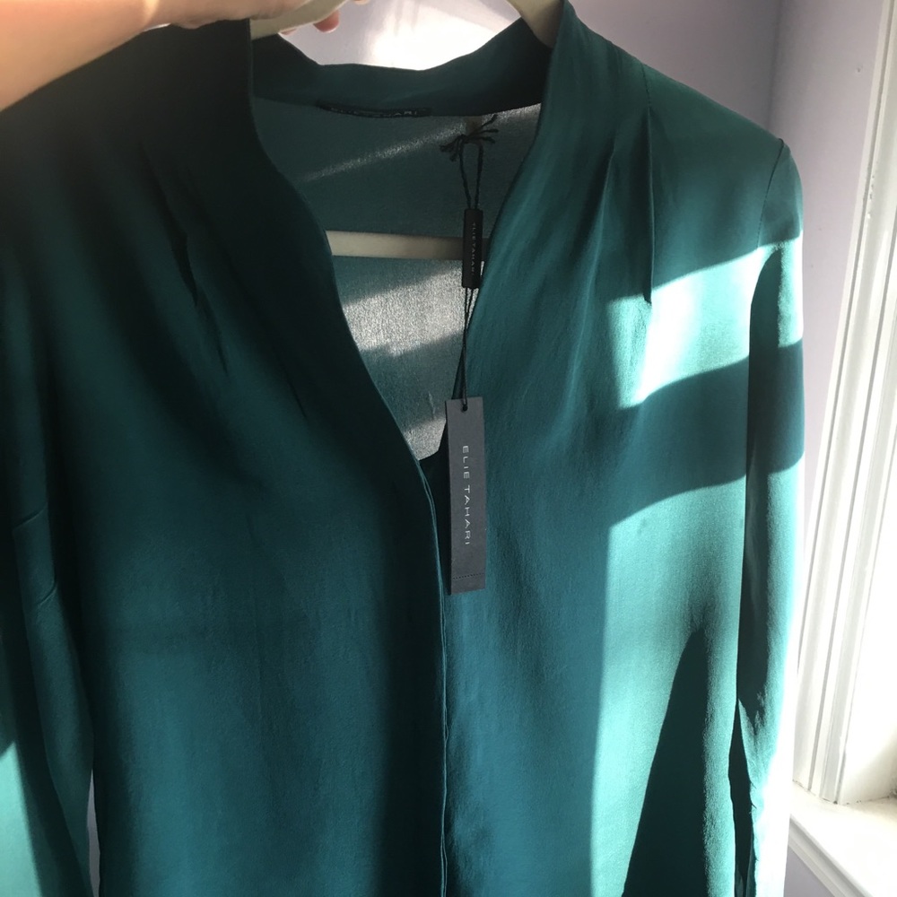 Tahari blouse has deodorant marks on the armpits.